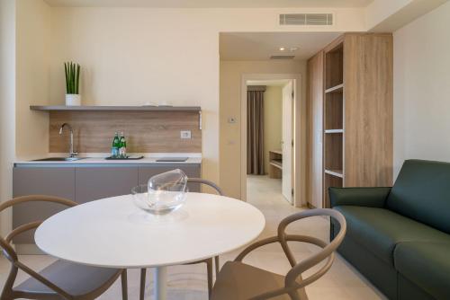 a living room with a white table and chairs at Palace Lido Hotel & Suites in Marina di Cecina