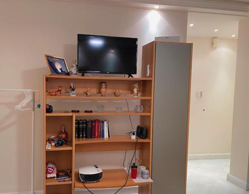 a television sitting on top of a book shelf at Pendeli's Luxury in Athens