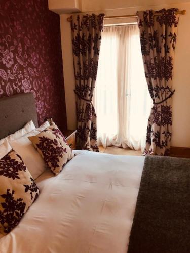 a bedroom with a white bed and a window at The Forge Guest Rooms in Long Whatton