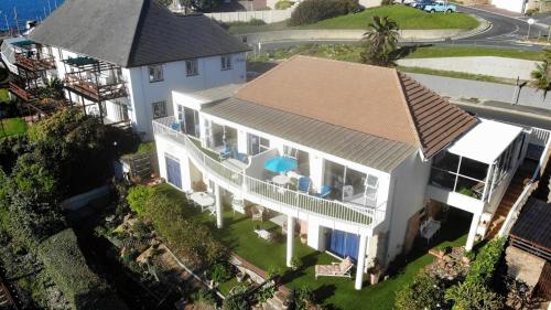 an aerial view of a white house with a roof at Paradise On the Bay in Fish Hoek