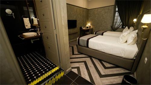 a hotel room with a bed and a bathroom at 1969 Business Suites @ Ipoh Garden in Ipoh