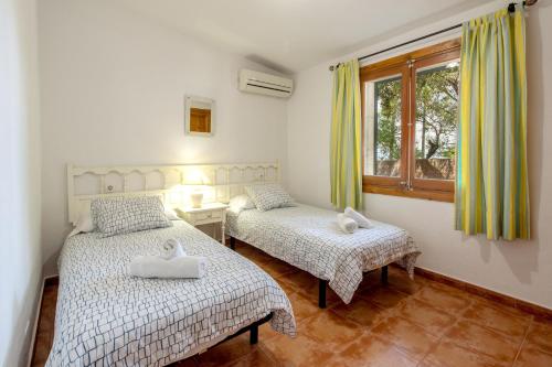 Säng eller sängar i ett rum på Villa Alzina