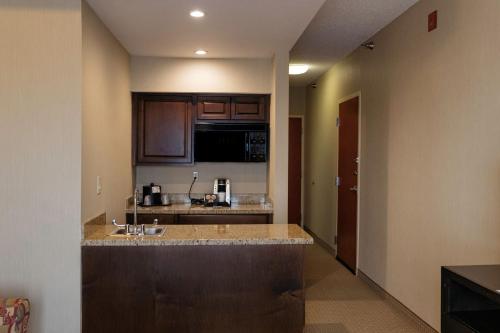 a kitchen with a sink and a counter top at Holiday Inn Express & Suites - Olathe North by IHG in Olathe