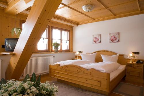 a bedroom with a wooden bed in a room at Landgasthaus Engel - Naturparkwirt in Höchenschwand