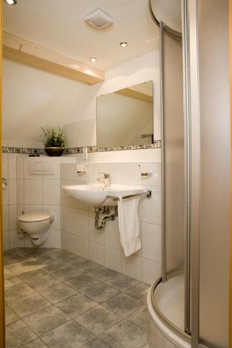 a bathroom with a sink and a toilet and a shower at Landgasthaus Engel - Naturparkwirt in Höchenschwand