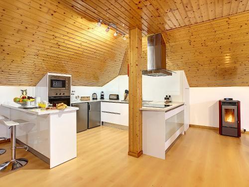a kitchen with white counters and a wooden ceiling at Casa Leão de Ouro by LovelyStay in São Jorge