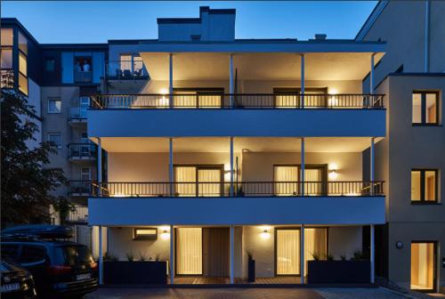 a white building with a balcony on the side of it at Kaiser 4 in Norderney