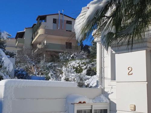 a building with snow on the side of it at Pendeli's Luxury in Athens