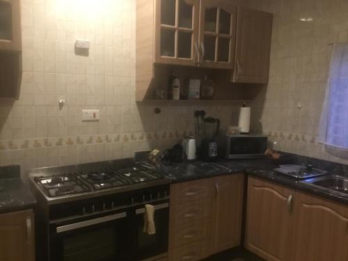 a kitchen with a stove and a counter top at 1 Bedroom Apartment in a Prime area in Accra