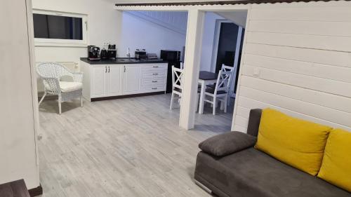 a living room with a couch and a kitchen at Pension St. Maria in Staré Hory