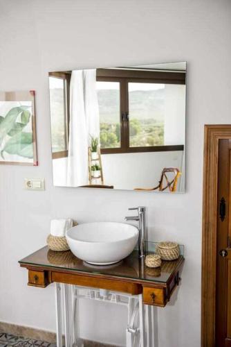 a bathroom with a white sink and a mirror at Casa Rural Don Lope en Priego de Córdoba in El Cañuelo
