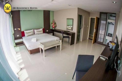 a bedroom with a bed and a desk in a room at SR Residence Hotel in Phetchabun