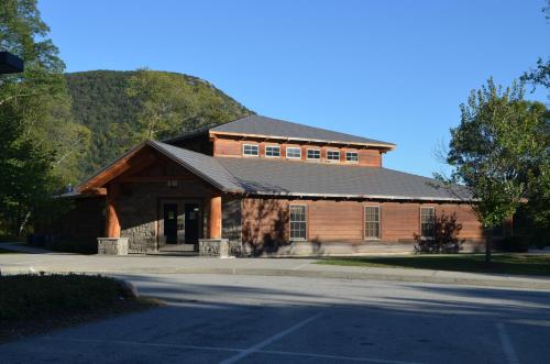 a large wooden building with a gambrel roof at Holiday Inn Express Hotel & Suites West Point-Fort Montgomery by IHG in Fort Montgomery