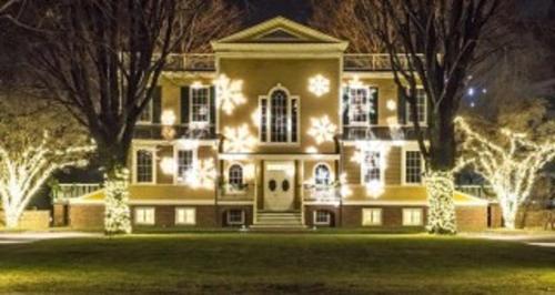 a large house with christmas lights in front of it at Holiday Inn Express Hotel & Suites West Point-Fort Montgomery by IHG in Fort Montgomery