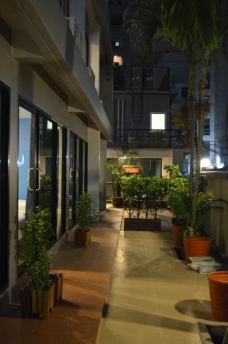 a hallway with potted plants in a building at Varinda Hostel in Bangkok