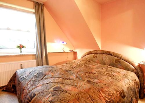 a bedroom with a bed and a window at Modern Apartment in Westerland-Sylt, 50 sqm, close to beaches in Westerland (Sylt)