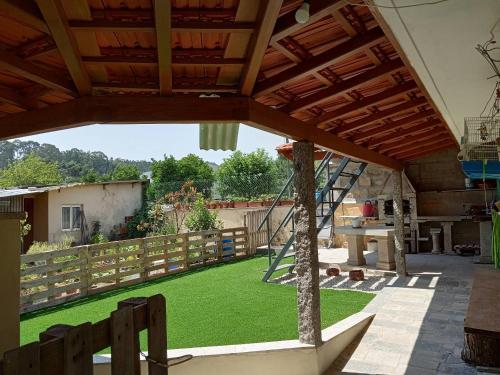 a garden with a lawn and a wooden fence at Casa das Flores in Santo Tirso