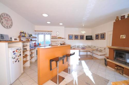 a kitchen with a counter and a living room at Penzión Belvia in Nová Lesná