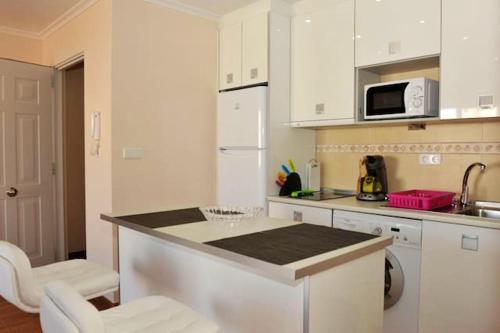 a kitchen with white cabinets and a counter top at Modern apartment in Torrevieja, 60 m², near beaches in Torrevieja
