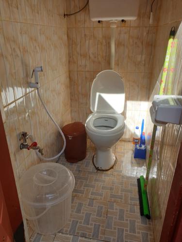 a bathroom with a toilet in a small room at Inviting 2-Bed House Komakundi Rural Kilimanjaro in Kimangaro