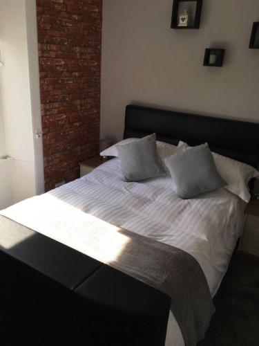 a bedroom with a large white bed with two pillows at Lovely 2- Bed Apartment in Hawick in Hawick