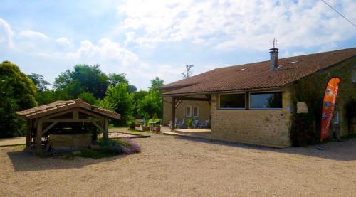 una pequeña casa de ladrillo con cenador en Appartement d'une chambre avec piscine partagee jardin amenage et wifi a Blaignac en Blaignac