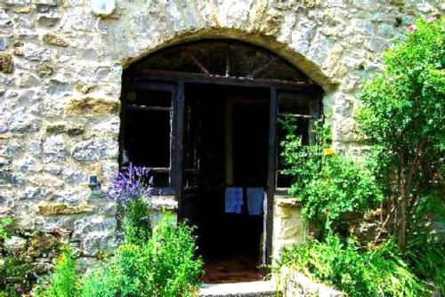 an entrance to a stone building with a door at Maison confortable en pleine nature près de Vesc avec jacuzzi in Vesc