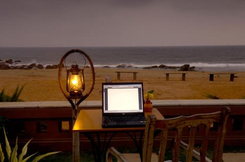 a laptop computer sitting on a table next to a beach at The Park Visakhapatnam in Visakhapatnam