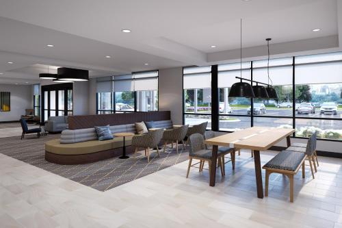 a living room with a couch and a table and chairs at Holiday Inn - Erie by IHG in Erie