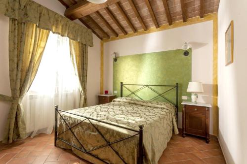 a bedroom with a bed and a window at Charming Apartment in Montepulciano 45m² with shared pool in Montepulciano