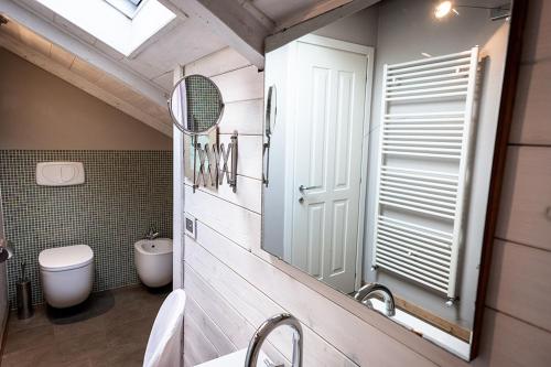 a bathroom with a sink and a toilet and a mirror at Tenuta Castello in Cerrione