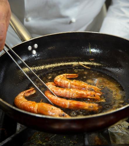 a bunch of sausages being fried in a wok at Hotel Orizzonte in Bellaria-Igea Marina