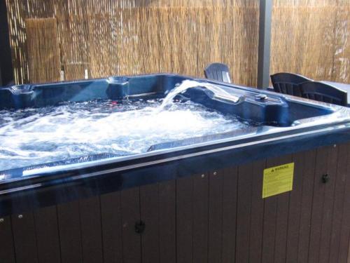 a hot tub with water being poured into it at Maison avec spa à They-Sous-Montfort, accueillant et moderne in They-sous-Montfort