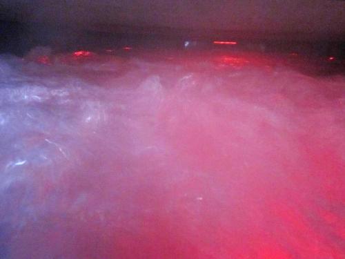 a bunch of pink smoke in a dark room at Maison avec spa à They-Sous-Montfort, accueillant et moderne in They-sous-Montfort