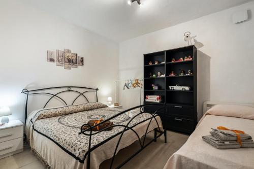 a bedroom with a bed and a black book shelf at Welcoming Apartment in Fabrica di Roma – 140 sqm, Private Pool in Fabrica di Roma