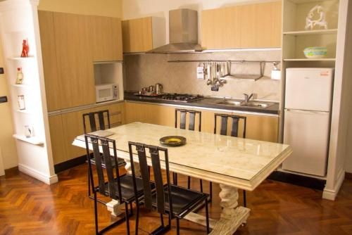 a kitchen with a table with chairs and a refrigerator at One bedroom apartement with sea view balcony and wifi at Boca Chica in Boca Chica