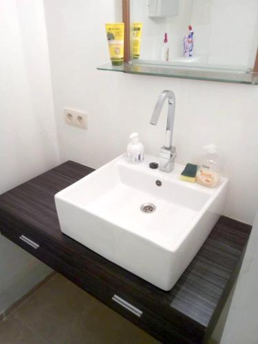 a bathroom with a white sink and a mirror at Comfortable Apartment in Waterloo with Jacuzzi - 78m² in Waterloo