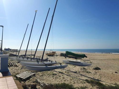 a row of sailboats sitting on the beach at Modern Apartment in Matalascañas with Shared Pool in Matalascañas