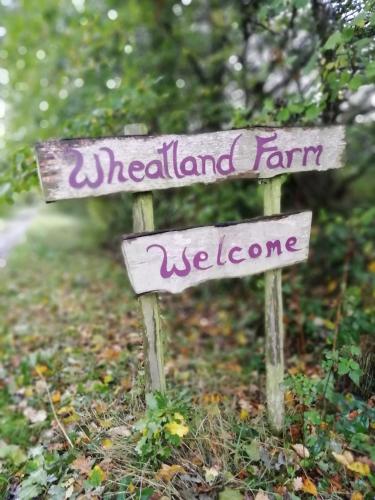 a sign that says melland farm and welcome at Devon Eco Lodges in Winkleigh