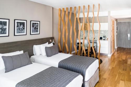 a bedroom with two beds and a dining room at CasaSur Bellini in Buenos Aires