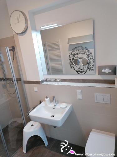 a bathroom with a sink and a mirror at Albert-INN-Glowe - barrierefrei & 3 Schlafzimmer & Coworking & Strandkorb-saisonal & Sauna im Haus & Fahrräder in Glowe