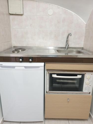 a small kitchen with a sink and a microwave at In the center of Messolonghi in Missolonghi