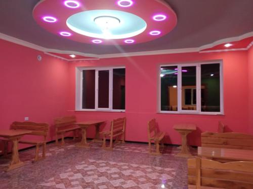 a room with a pink wall with a table and chairs at Sevan Backstage Garden in Sevan