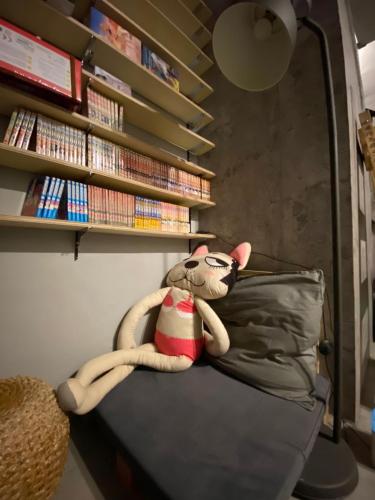 a stuffed animal is sitting on a bed at Art Turtle in Longjing