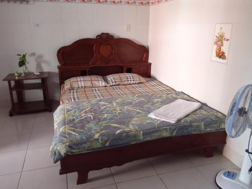 a bedroom with a bed with a quilt on it at Motel HAPPY in Bà Rịa