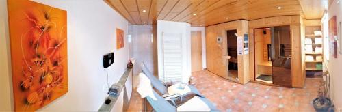 a living room with a view of a kitchen and a room with at Jakoberhof- Bergeweise Urlaubsfeeling in Untertscheltsch