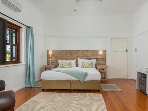 a bedroom with a large bed and a fireplace at Abbotts Hill in Malmesbury