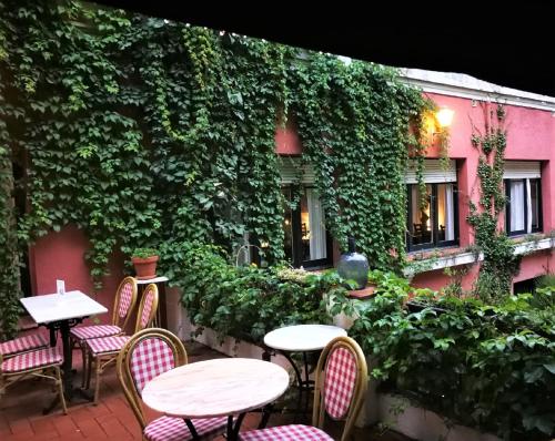 a patio with tables and chairs in front of a building at Hostal Montsoliu in Arbúcies