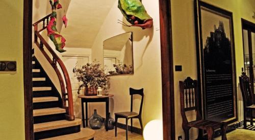 a room with a staircase and a table and chairs at Hostal Montsoliu in Arbúcies