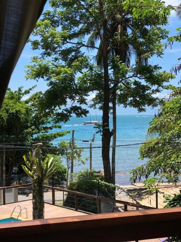 a view of the beach from a resort balcony at La Bella Suítes in Ilhabela